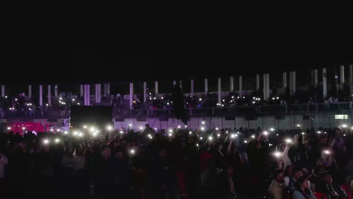 Phone lights across the stadium crowd